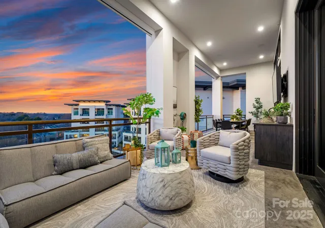 a living room with furniture and a view of kitchen