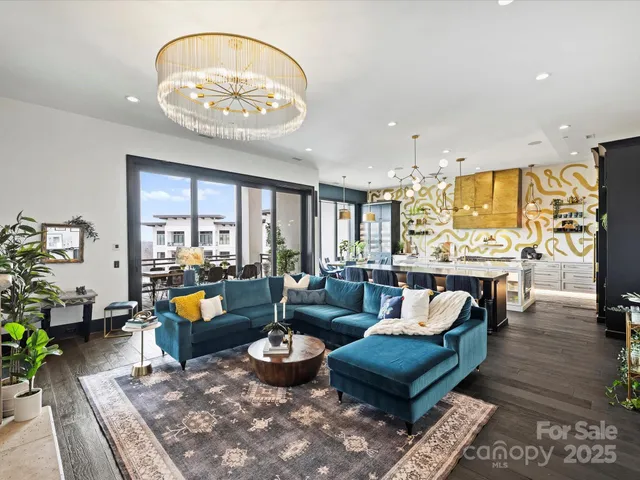 a living room with fireplace furniture and a chandelier