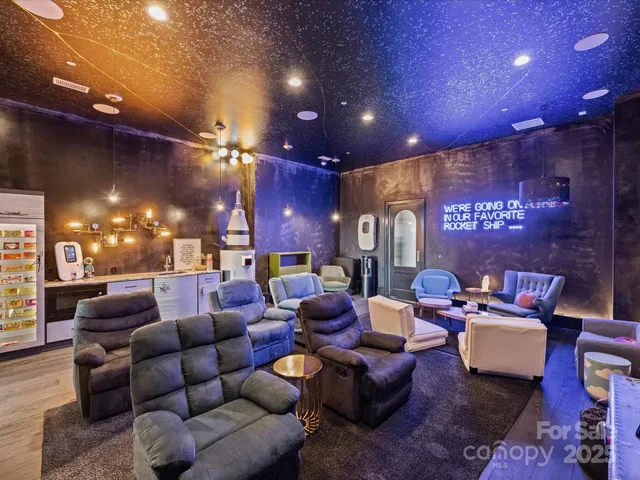 a media room with lots of chairs and a projector