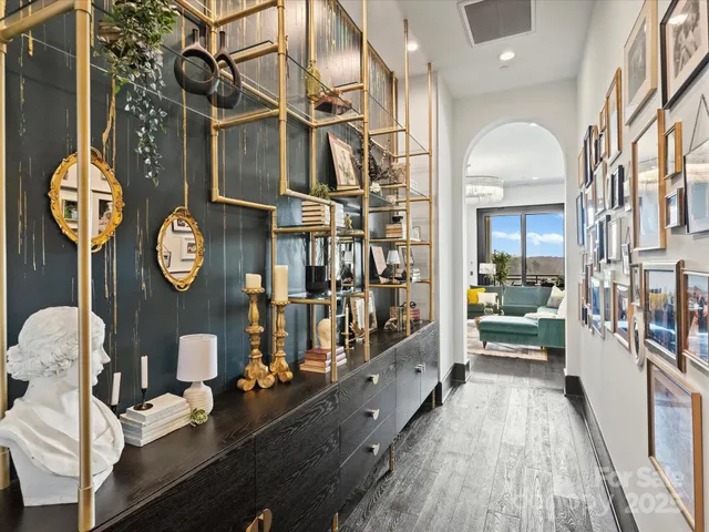 a very nice looking room with a large mirror on a table and a clock on the dresser