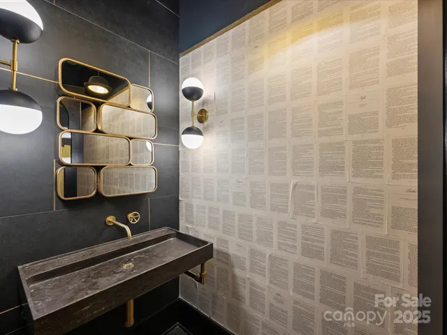 a bathroom with a sink mirror and vanity