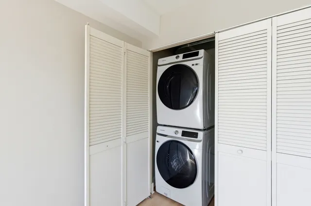 a view of a hallway with washer and dryer