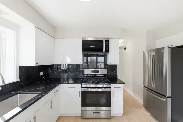 a kitchen with a refrigerator stove and sink