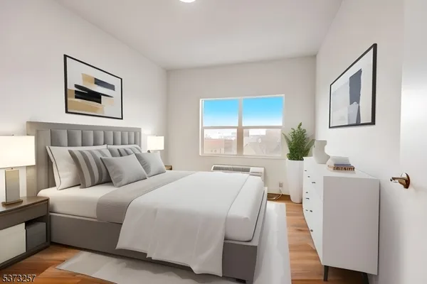 a bedroom with a bed and a large window