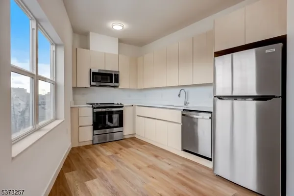 a kitchen with a refrigerator stove and microwave