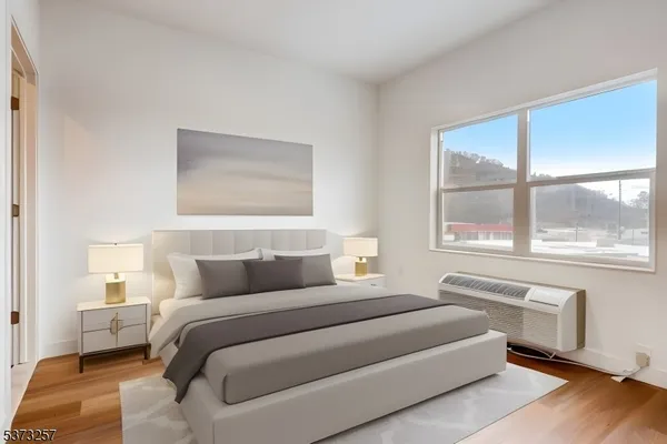 a bedroom with a large bed and a large window