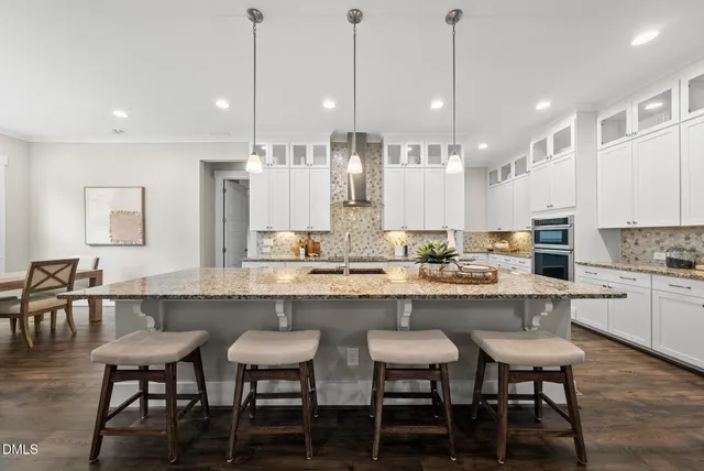 a large kitchen with a table and chairs