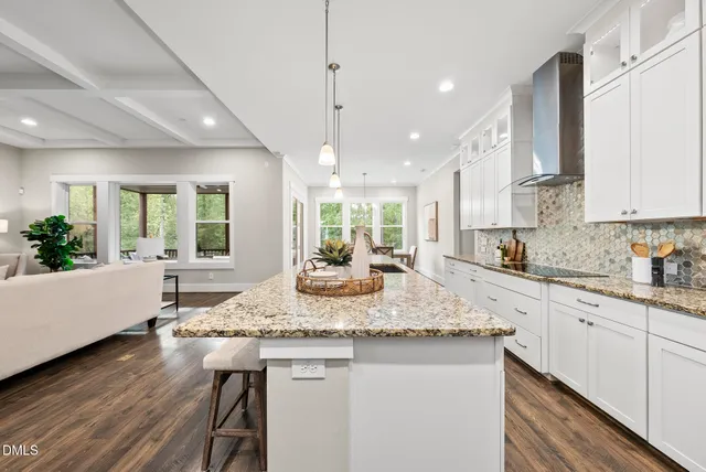 a kitchen with stainless steel appliances granite countertop white cabinets and a granite counter tops