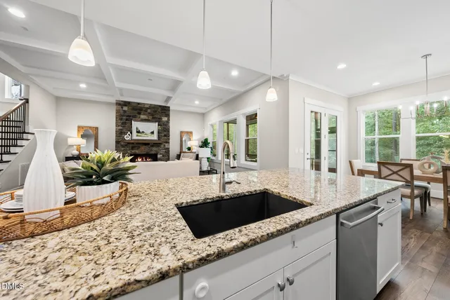 a kitchen with center island wooden floor white appliances and cabinets
