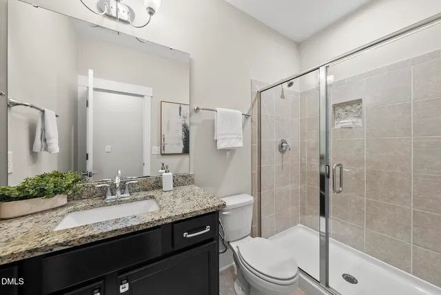 an empty room with wooden floor chandelier fan and windows