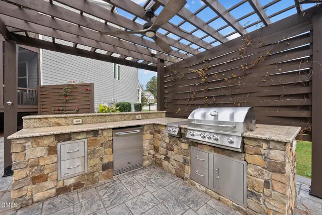 a view of a patio with table and chairs with wooden floor and fence
