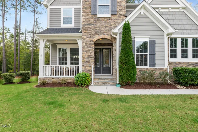 a utility room with stainless steel appliances wooden cabinets and a stove
