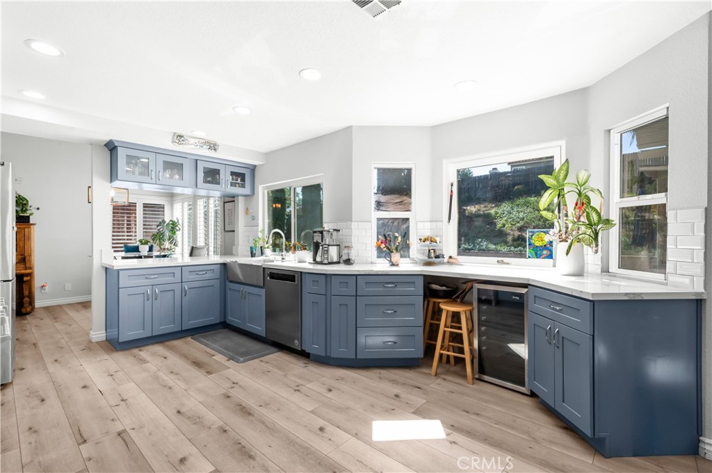 19465 Kinnow Lane Riverside, CA 92508 - Photo 13 of 61 a room with wooden floors and white cabinets