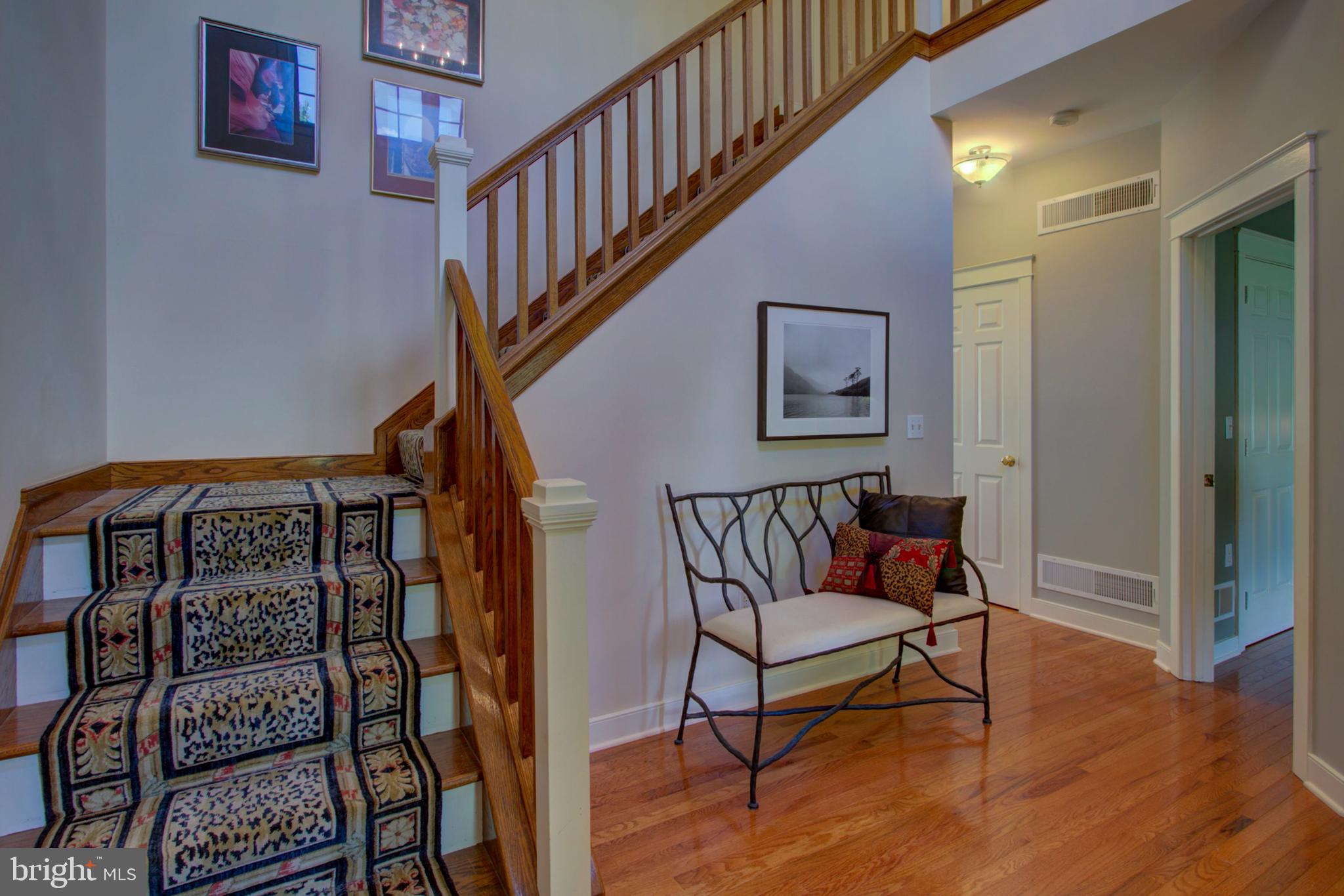 382 Rumford Road Lititz, PA 17543 - Photo 6 of 63 a reading room with wooden floor stairs and a book shelf