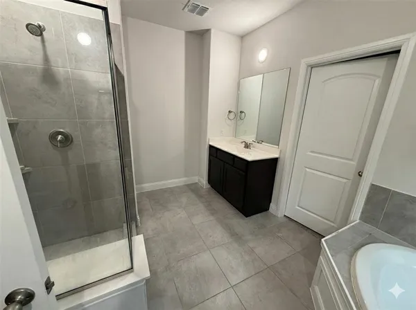 a bathroom with a bathtub and a sink