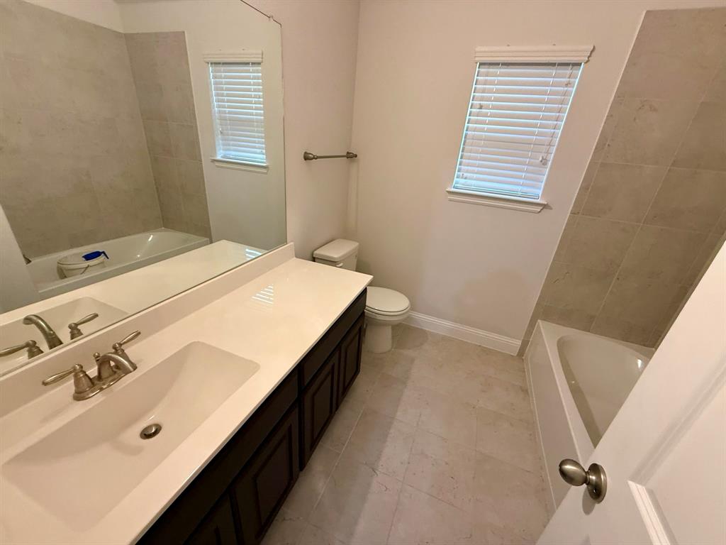 6842 Albany Park Frisco, TX 75034 - Photo 16 of 21 a spacious bathroom with a double vanity sink and a tub