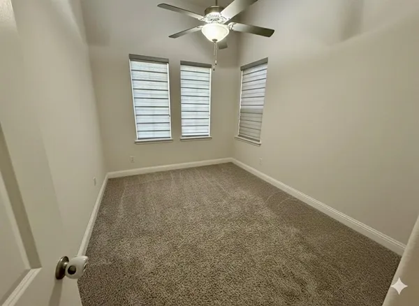 a view of a livingroom with a ceiling fan and window