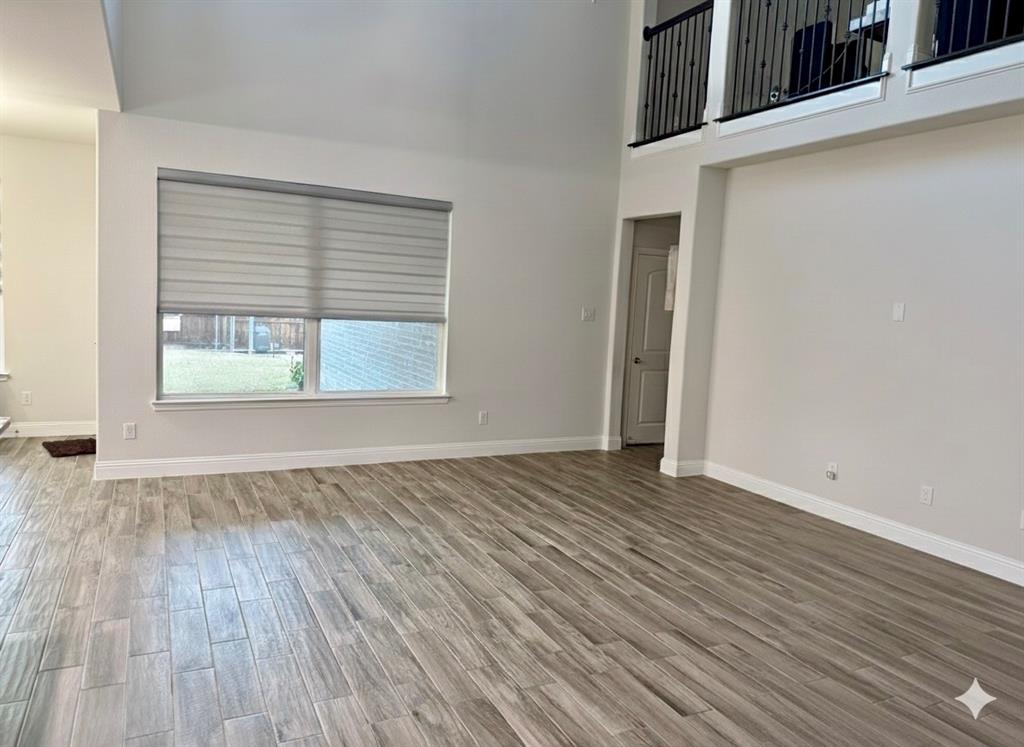6842 Albany Park Frisco, TX 75034 - Photo 9 of 21 an empty room with wooden floor and windows