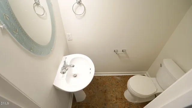 a bathroom with a sink mirror and toilet
