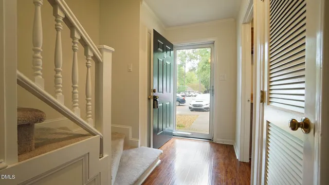 a view of a hallway with wooden floor and staircase