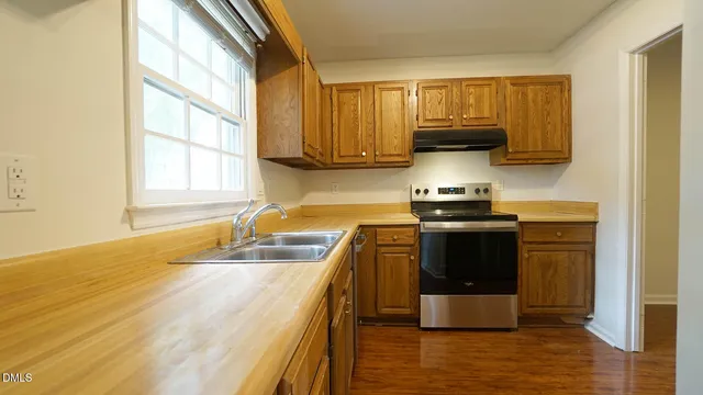 a kitchen with a stove a sink and a microwave