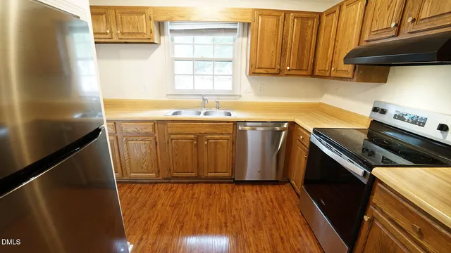 a kitchen with a sink stove and cabinets