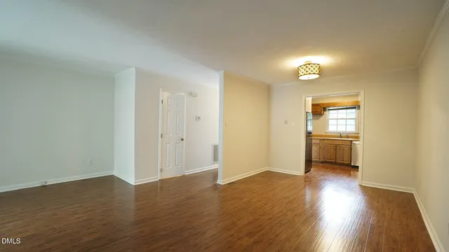 a view of a room with wooden floor and a window