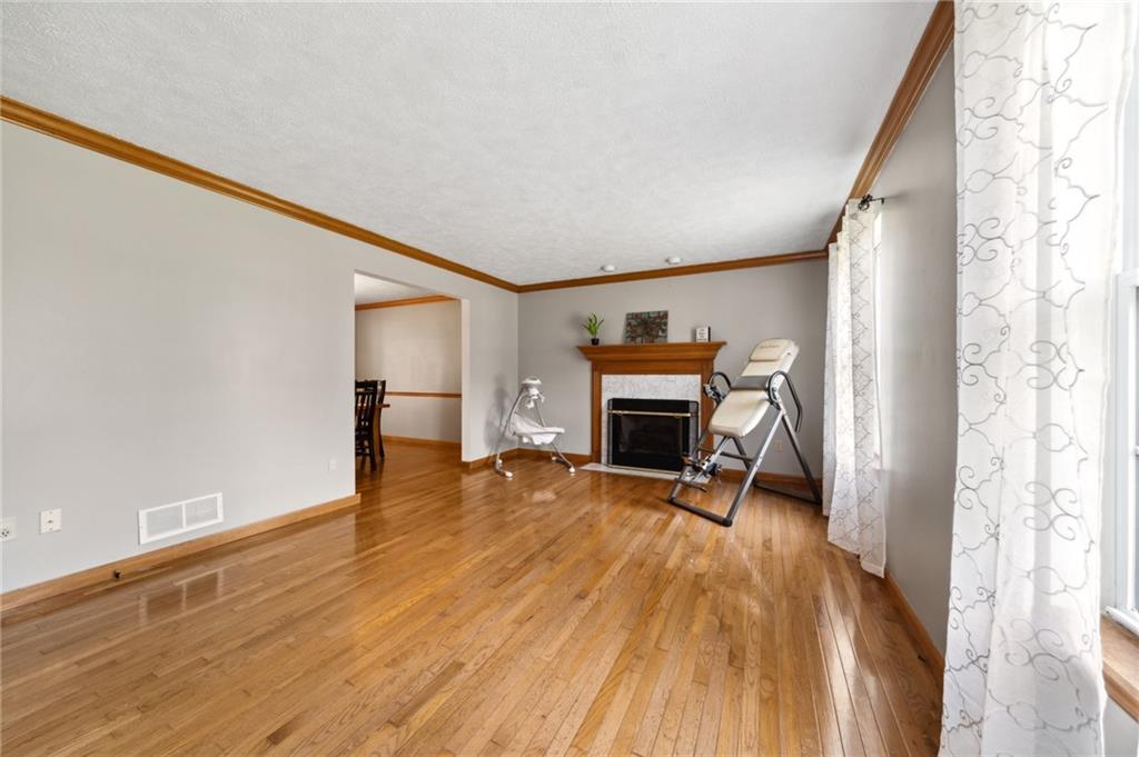 116 Buttercup School Road Renfrew, PA 16053 - Photo 12 of 34 a view of empty room with fireplace and wooden floor