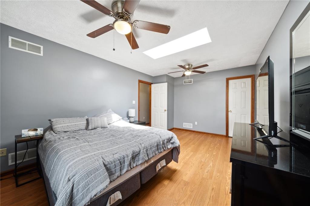 116 Buttercup School Road Renfrew, PA 16053 - Photo 25 of 34 a bedroom with a bed ceiling fan and a large mirror