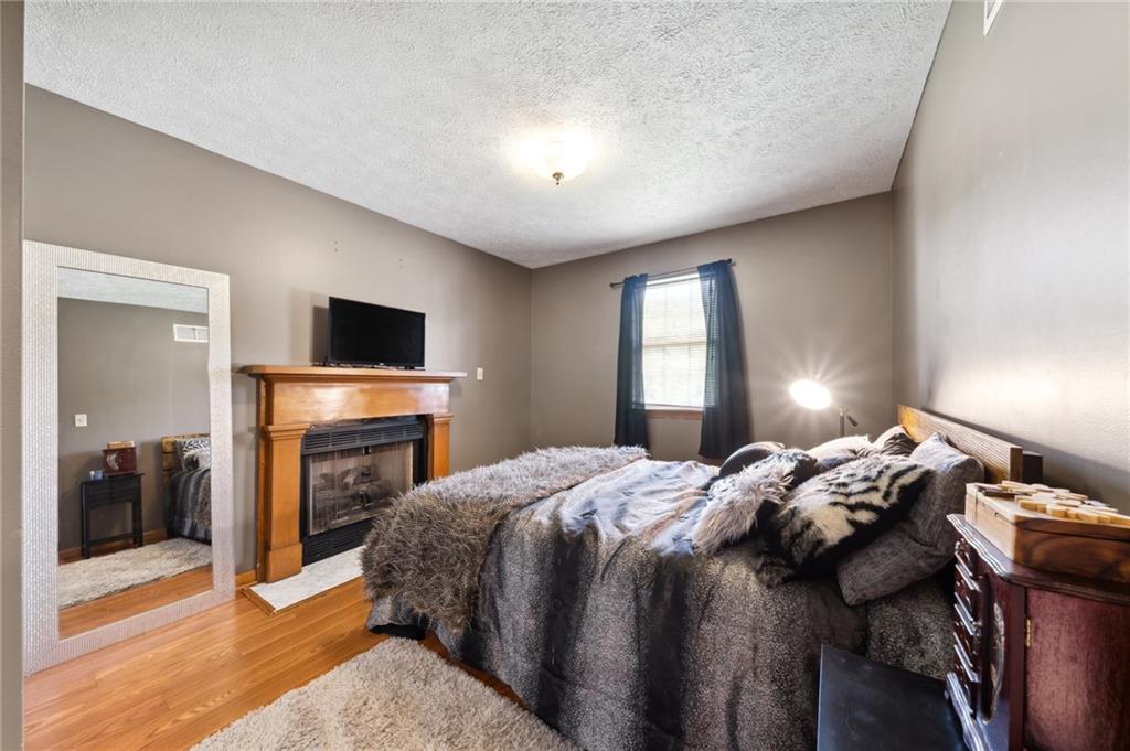 116 Buttercup School Road Renfrew, PA 16053 - Photo 29 of 34 a bedroom with a bed and a fireplace