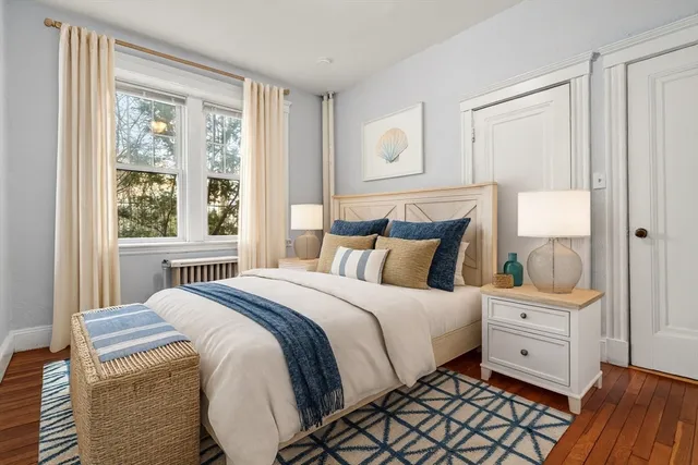 a bedroom with a large bed and a window