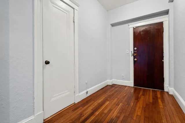 a view of a room with wooden floor and closet