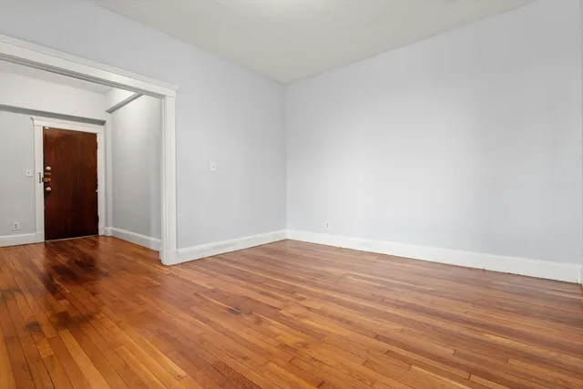 a view of an empty room and wooden floor