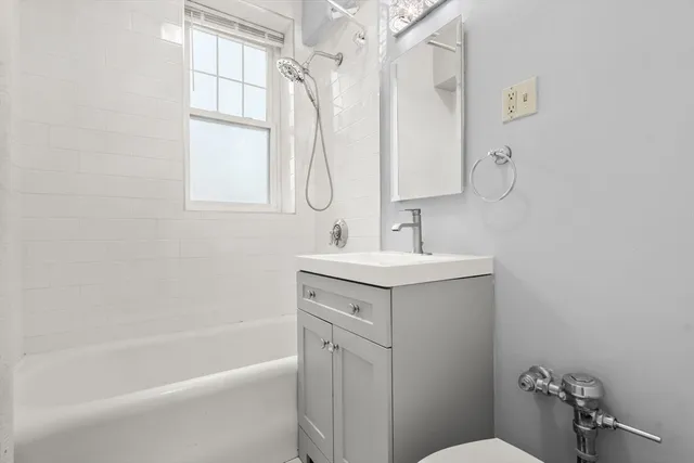 a bathroom with a sink mirror toilet and bathtub