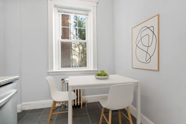 a view of a dining room with furniture and a window