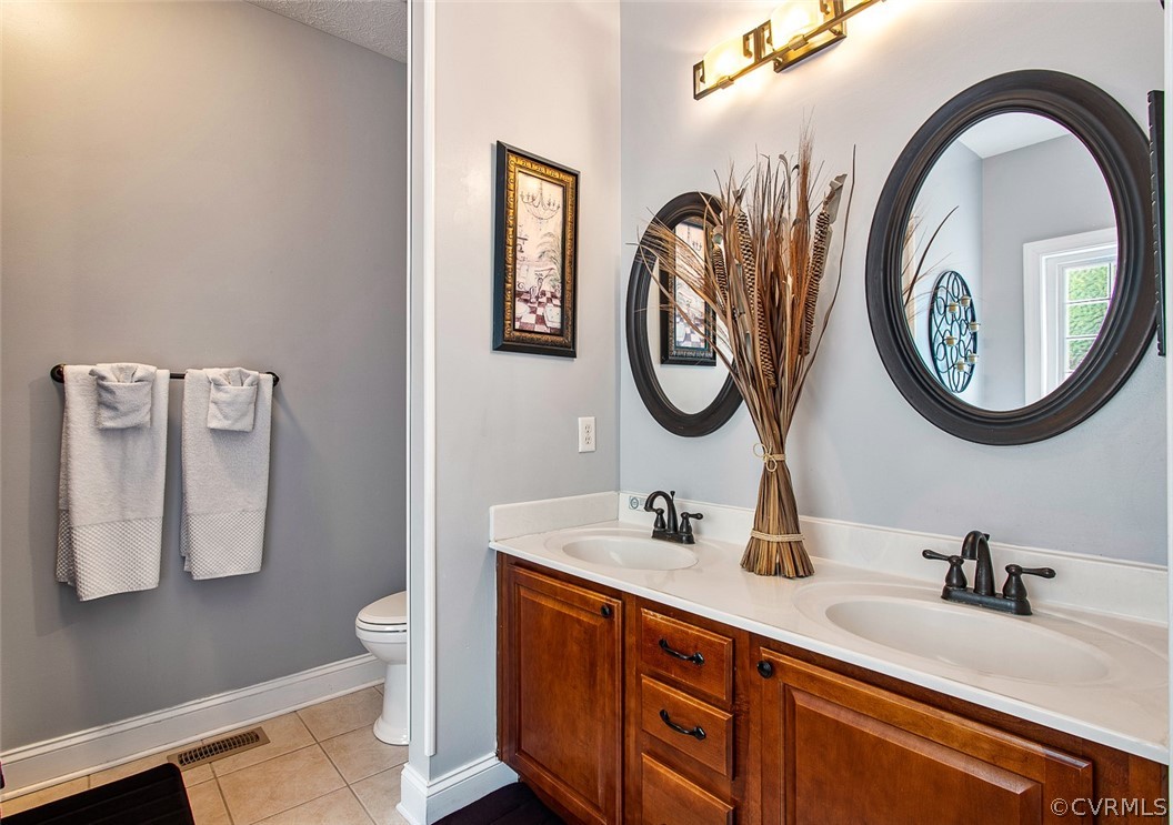 3001 Barnack Road Midlothian, VA 23112 - Photo 23 of 37 a bathroom with a double vanity sink and a mirror