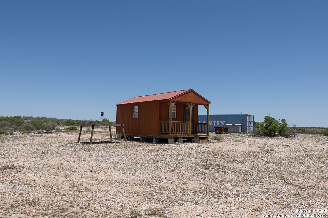 1935 Wolf Spgs Road Comstock, TX 78837 - Photo 11 of 15 a view of a house with a yard