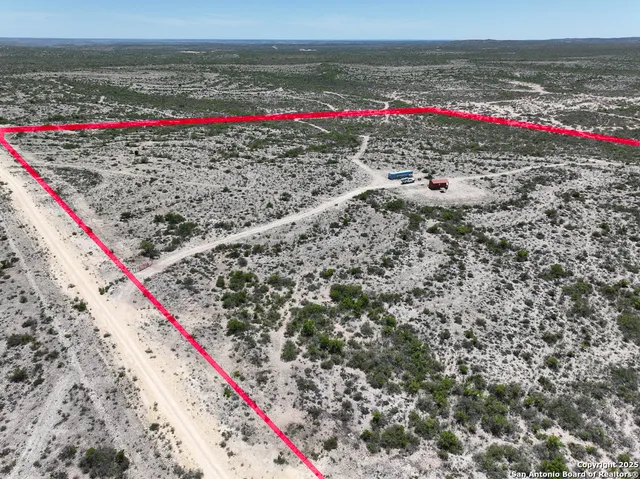 a view of swimming pool with red and table