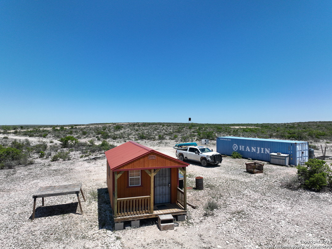 1935 Wolf Spgs Road Comstock, TX 78837 - Photo 2 of 15 a view of a terrace with a bench