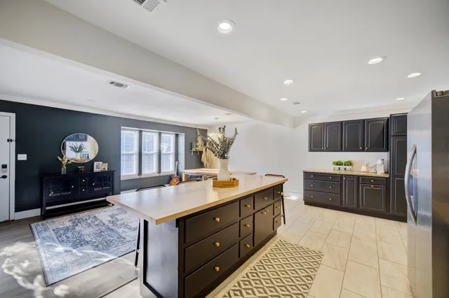 a kitchen with a refrigerator and a stove top oven