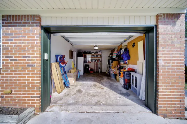 a view of a garage with a white car parked