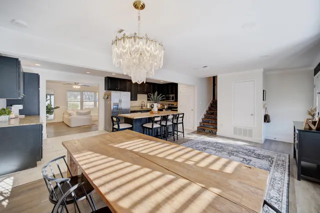 a kitchen with stainless steel appliances kitchen island granite countertop a refrigerator and a stove top oven