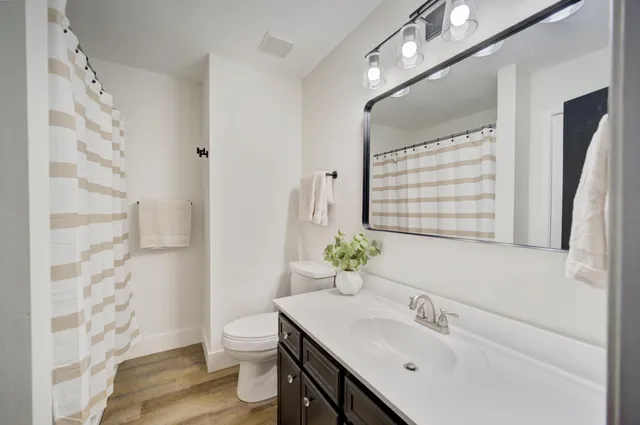 a bathroom with a shower curtain and a window