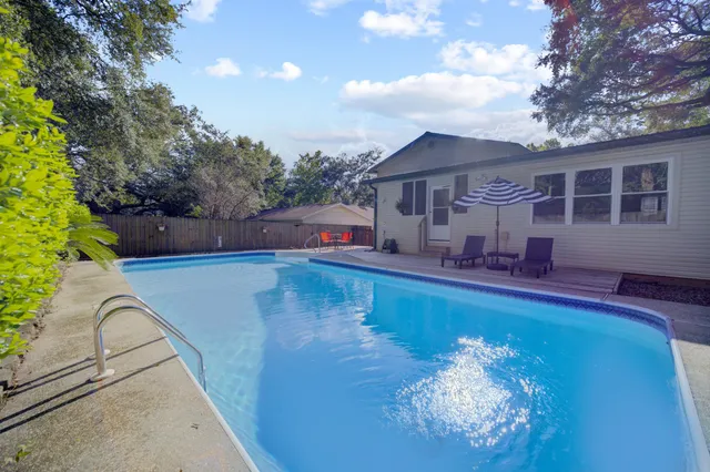 swimming pool view with a seating space