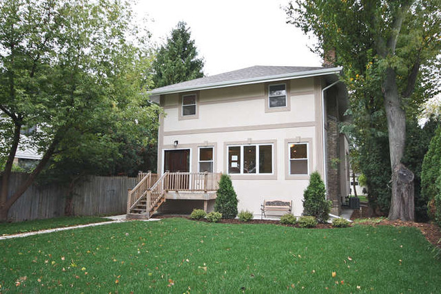 1035 Willow Road Winnetka, IL 60093 - Photo 1 of 25 a front view of a house with a garden