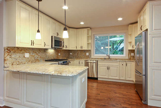 1035 Willow Road Winnetka, IL 60093 - Photo 2 of 25 a kitchen with white cabinets and sink