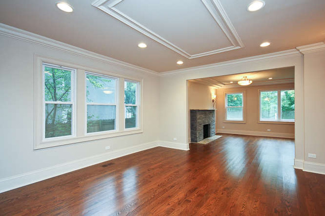 1035 Willow Road Winnetka, IL 60093 - Photo 11 of 25 a view of empty room with wooden floor and fireplace