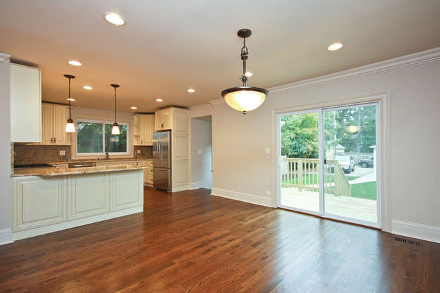 1035 Willow Road Winnetka, IL 60093 - Photo 12 of 25 a kitchen with stainless steel appliances granite countertop a sink a refrigerator and wooden floor