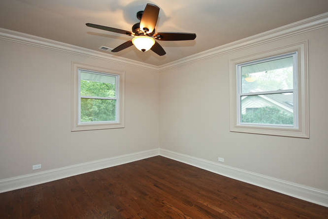1035 Willow Road Winnetka, IL 60093 - Photo 18 of 25 a view of an empty room with wooden floor and a window