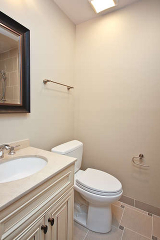1035 Willow Road Winnetka, IL 60093 - Photo 21 of 25 a white toilet sitting next to a bathroom sink